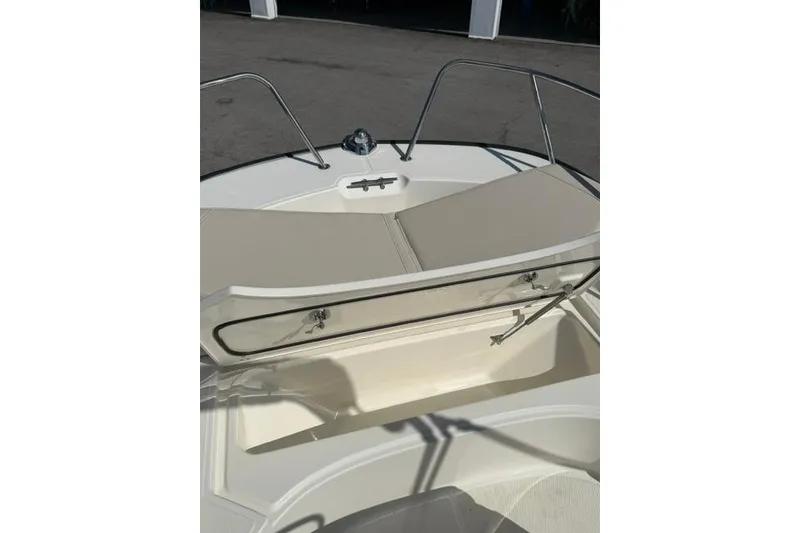 Slide: The Image of 2021 Boston Whaler 170 Montauk boat with open storage compartment and cushioned seating. - 7