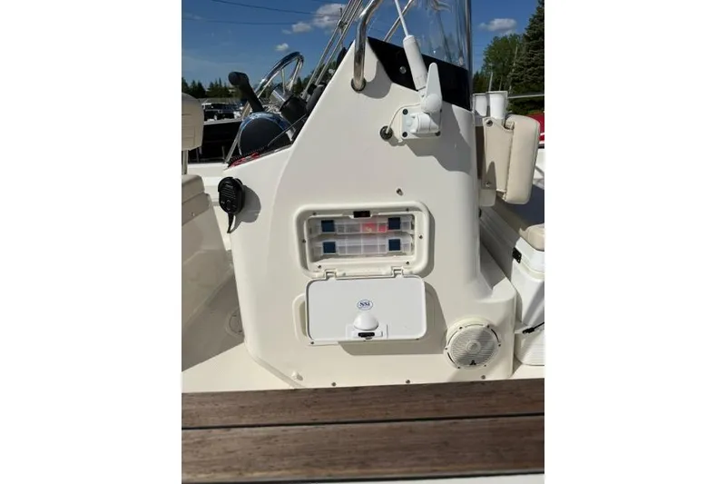 Slide: The Image of 2021 Boston Whaler 170 Montauk console with storage compartments and steering wheel. - 8