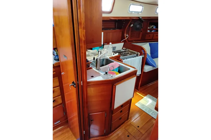 Slide: The Image of Interior of 1986 Sabre 38 sailboat with wooden cabinetry and compact kitchen area. - 10