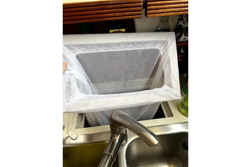 Slide: The Image of White mesh laundry bag over sink on Sabre 38, 1986 model. - 11