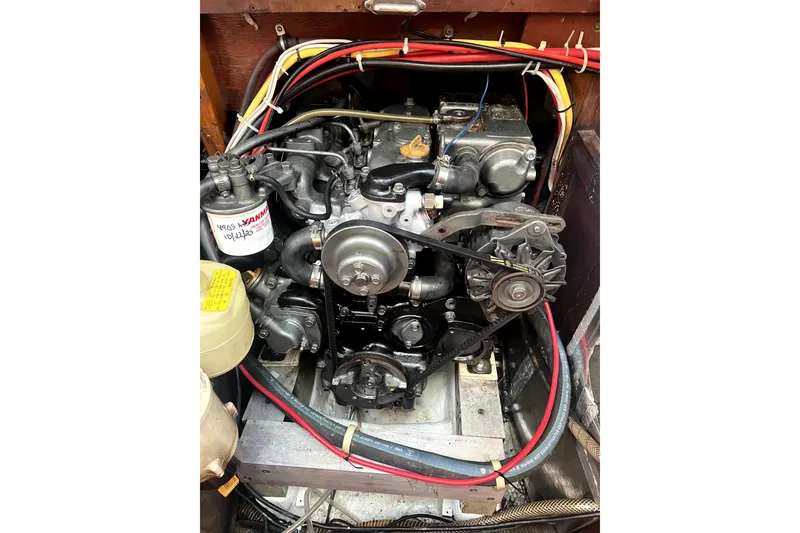 Slide: The Image of Engine compartment of a 1986 Sabre 38 sailboat, showcasing wiring and mechanical components. - 18