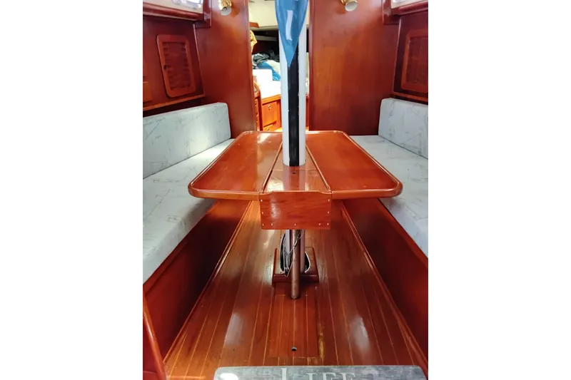 Slide: The Image of Interior of 1986 Sabre 38 sailboat with wooden table and cushioned seating. - 27