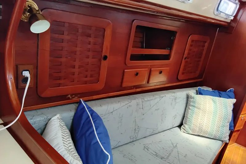 Slide: The Image of Interior of 1986 Sabre 38 sailboat with wooden cabinetry and cushioned seating. - 28