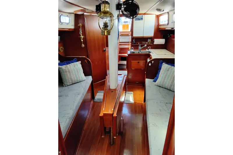 Slide: The Image of Interior of 1986 Sabre 38 sailboat with cozy seating and wooden finishes. - 29