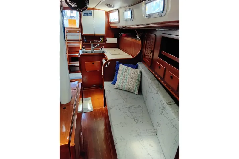 Slide: The Image of Interior of 1986 Sabre 38 sailboat with wooden cabinetry and cozy seating area. - 30