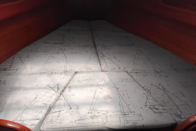 Slide: The Image of Interior of a 1986 Sabre 38 sailboat with nautical-themed cushions. - 31