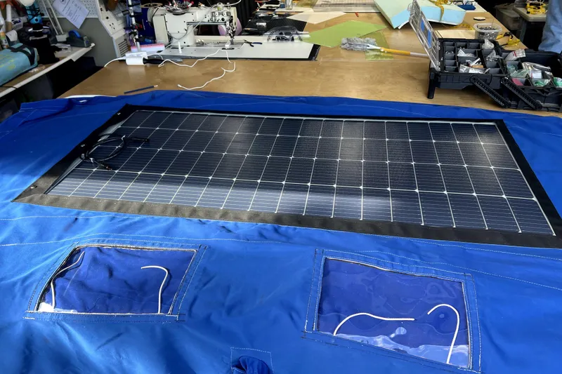 Slide: The Image of Solar panel integrated into blue fabric for Sabre 38, 1986 model, on a workshop table. - 32