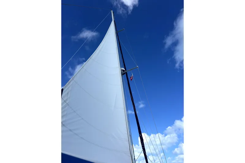 Slide: The Image of Sail of 1986 Sabre 38 yacht against a clear blue sky. - 36
