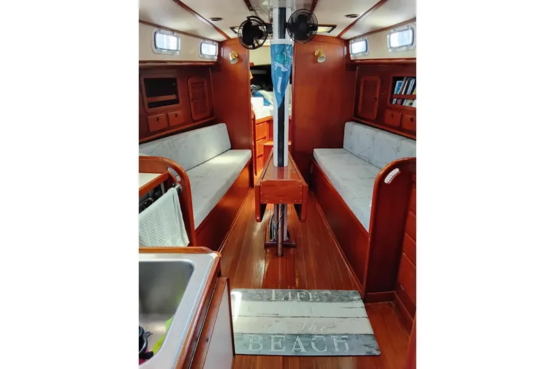 Slide: The Image of Interior of 1986 Sabre 38 sailboat with wooden finish and cozy seating. - 7