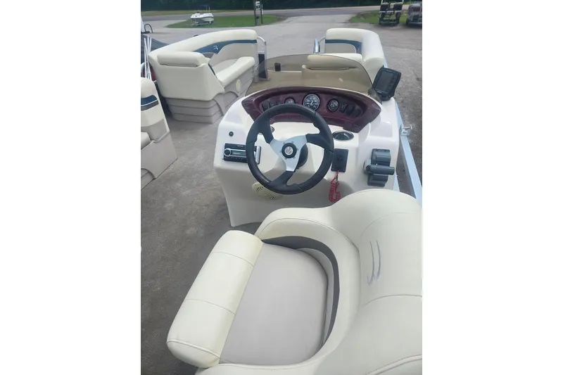 Slide: The Image of Interior view of a 2009 Bennington 2275SL boat with steering wheel and seating. - 10