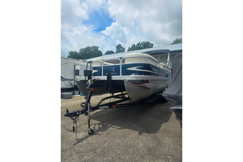 Slide: The Image of 2009 Bennington 2275SL pontoon boat on trailer under cloudy sky. - 4