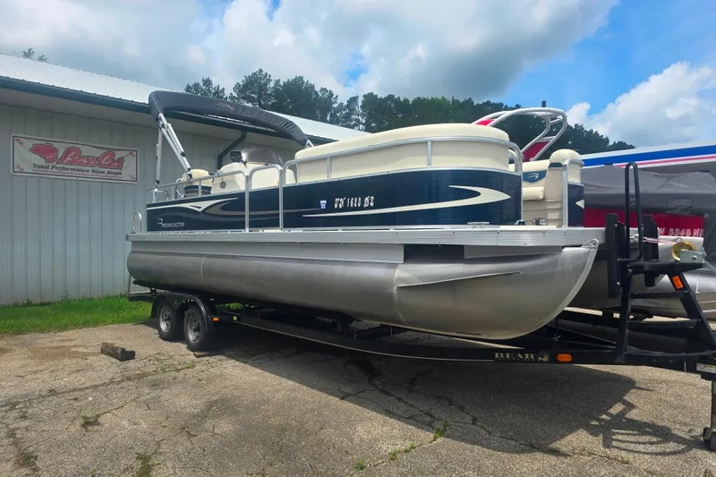 Slide: The Image of 2009 Bennington 2275SL pontoon boat on trailer, parked outside a building. - 5