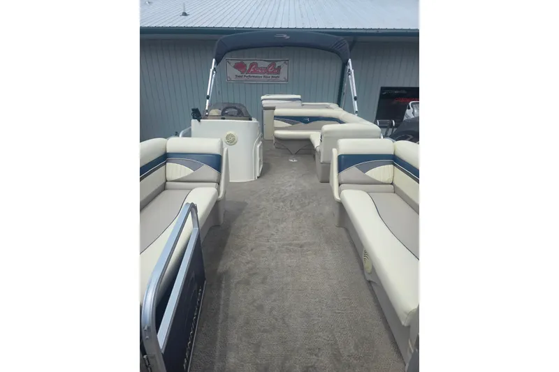 Slide: The Image of 2009 Bennington 2275SL pontoon boat interior with beige seating and blue accents. - 6