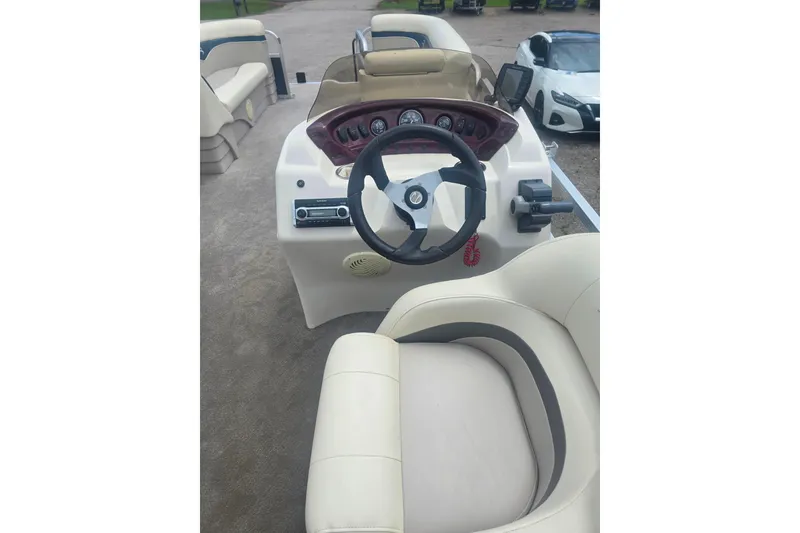 Slide: The Image of 2009 Bennington 2275SL boat interior with steering wheel and dashboard controls. - 9