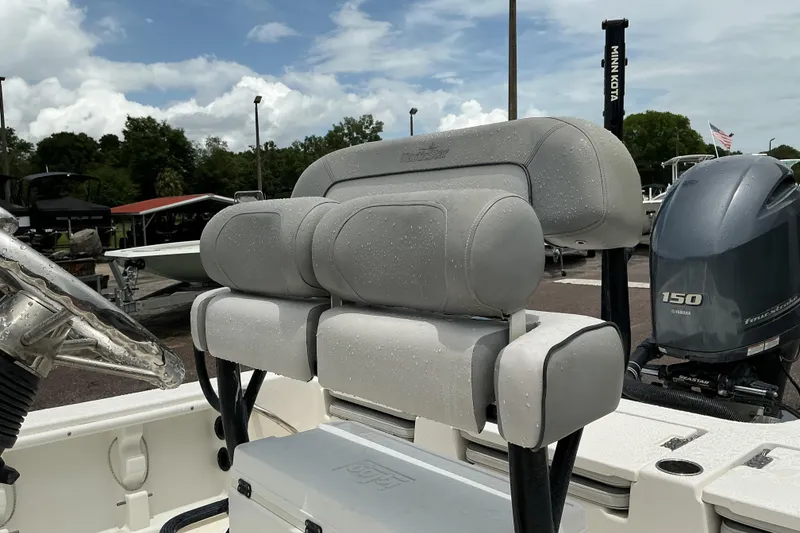 Slide: The Image of 2022 NauticStar 215 XTS Shallow Bay boat with Yamaha 150 engine, featuring cushioned seating. - 10
