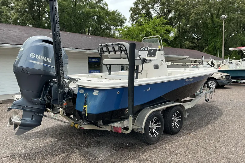 Slide: The Image of 2022 NauticStar 215 XTS Shallow Bay boat with Yamaha engine on trailer. - 3