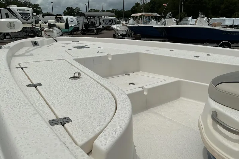 Slide: The Image of 2022 NauticStar 215 XTS Shallow Bay boat deck, showcasing spacious seating and storage. - 6