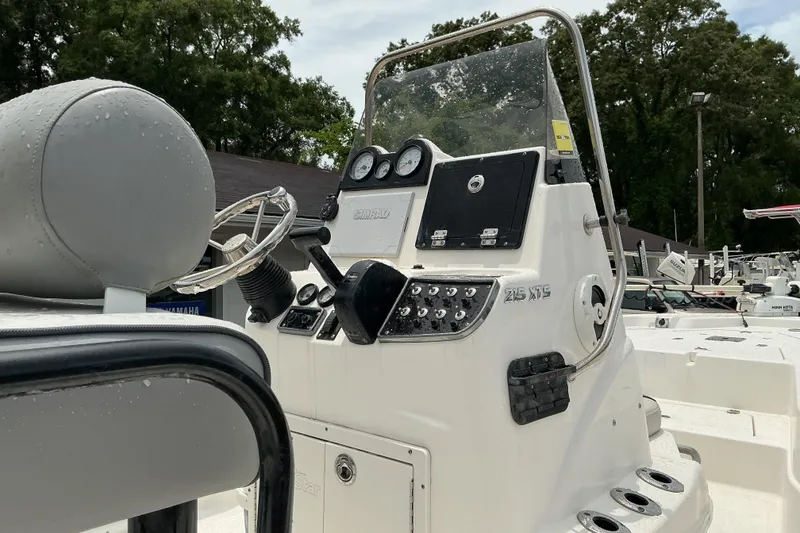 Slide: The Image of 2022 NauticStar 215 XTS Shallow Bay boat console with steering wheel and controls. - 8