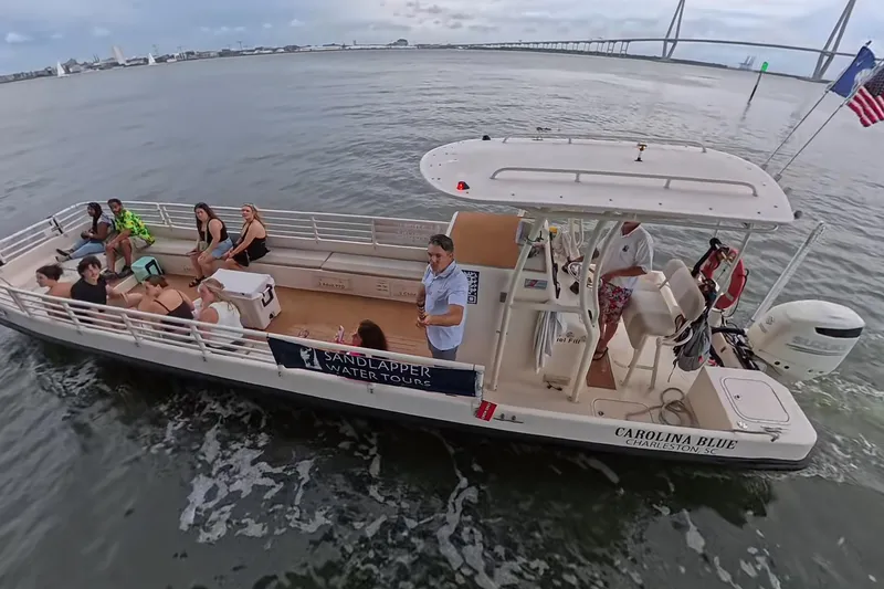 Slide: The Image of Tour boat "Carolina Blue" by Henriksen Design Group, 2023, on water with passengers enjoying the view. - 6
