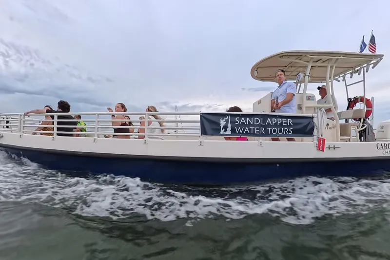 Slide: The Image of Boat on water with passengers enjoying Sandlapper Water Tours, Custom Henriksen Design Group, 2023. - 7