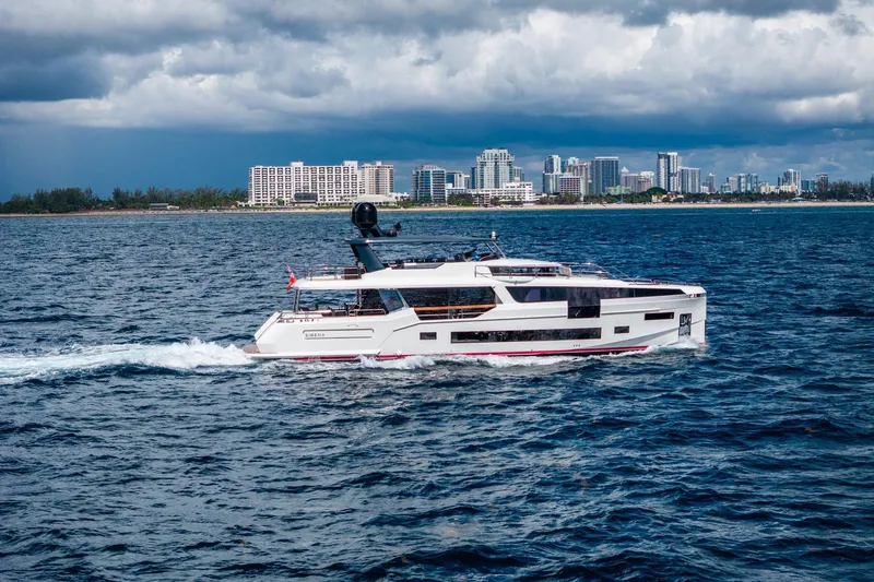 Slide: The Image of Luxury Sirena 88 yacht cruising near a city skyline, 2021 model. - 6