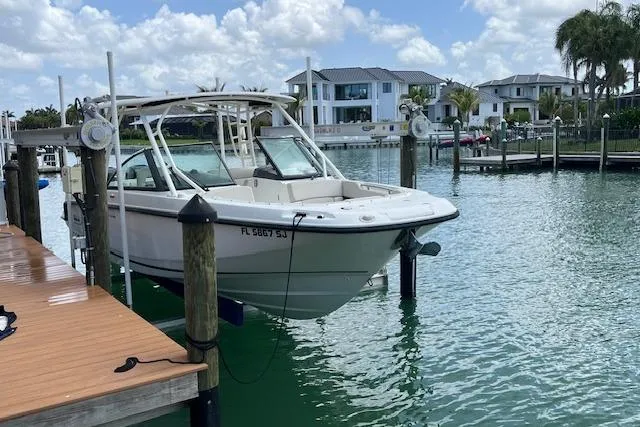 The Image of 2015 Boston Whaler 270 Vantage docked in a scenic marina setting. - 0