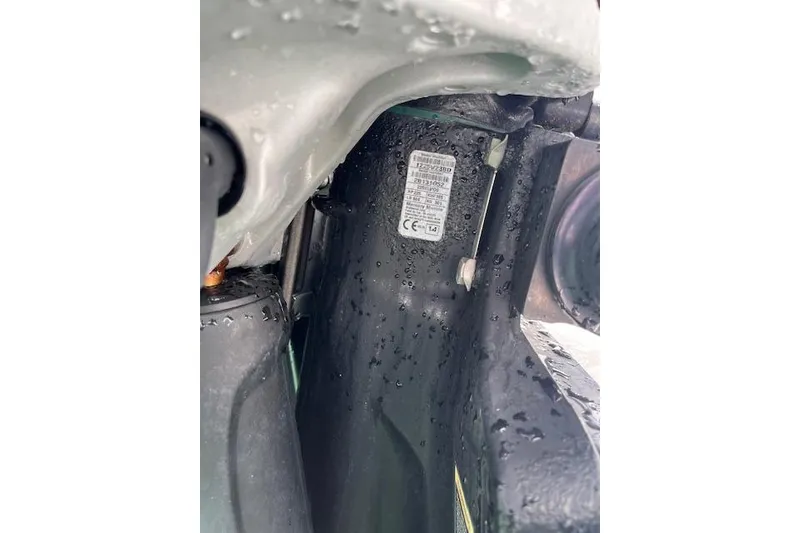 Slide: The Image of Close-up of a 2015 Boston Whaler 270 Vantage boat component with visible label and water droplets. - 12