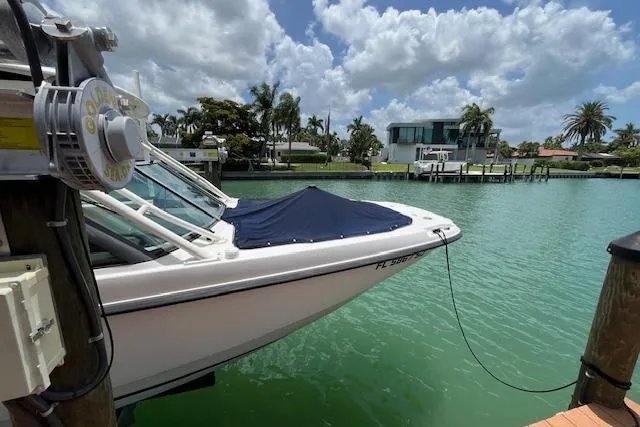 Slide: The Image of 2015 Boston Whaler 270 Vantage docked on turquoise water under a partly cloudy sky. - 16
