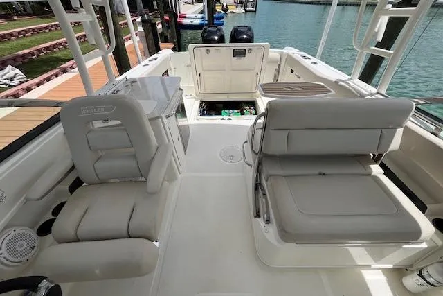 Slide: The Image of 2015 Boston Whaler 270 Vantage boat interior with seating and open storage compartment. - 20