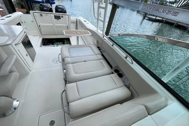 Slide: The Image of 2015 Boston Whaler 270 Vantage boat interior with seating and open storage compartment. - 22