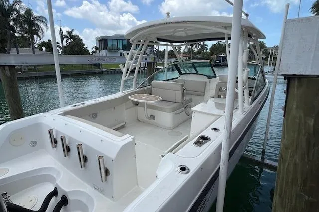 Slide: The Image of 2015 Boston Whaler 270 Vantage boat docked, featuring spacious seating and sleek design. - 3