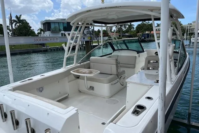 Slide: The Image of 2015 Boston Whaler 270 Vantage boat docked, featuring spacious seating and sleek design. - 5