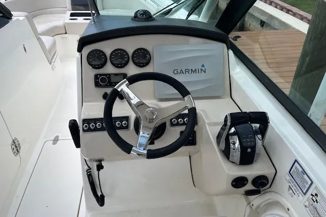 Slide: The Image of Cockpit of 2015 Boston Whaler 270 Vantage with Garmin navigation system and steering controls. - 9