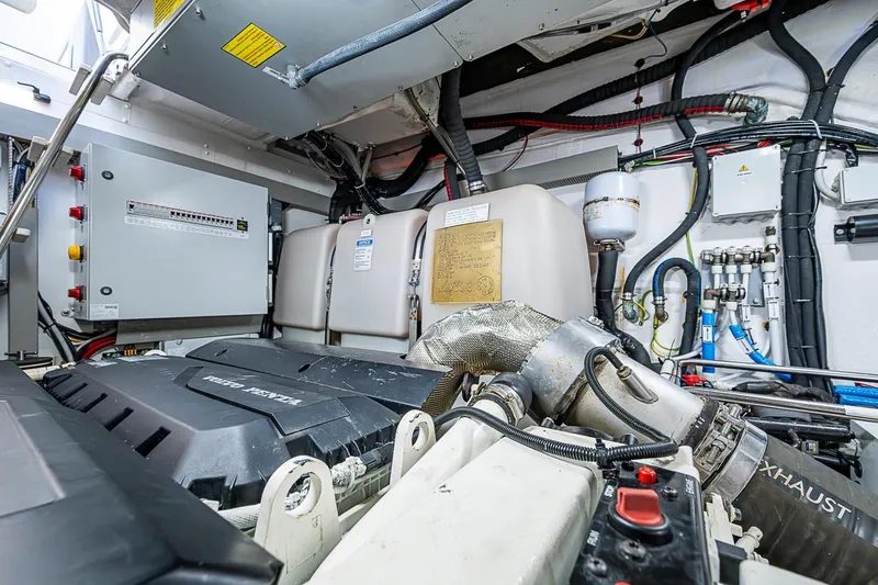 Slide: The Image of Engine room of 2019 Azimut Atlantis 51 yacht, featuring Volvo Penta components and complex wiring. - 65