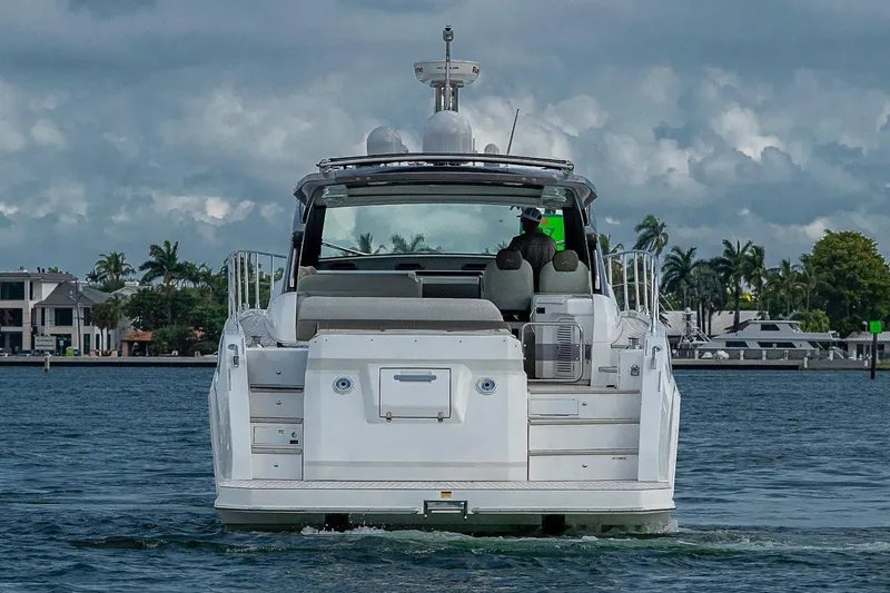 Slide: The Image of 2019 Azimut Atlantis 51 yacht cruising on a scenic waterway with palm trees. - 8