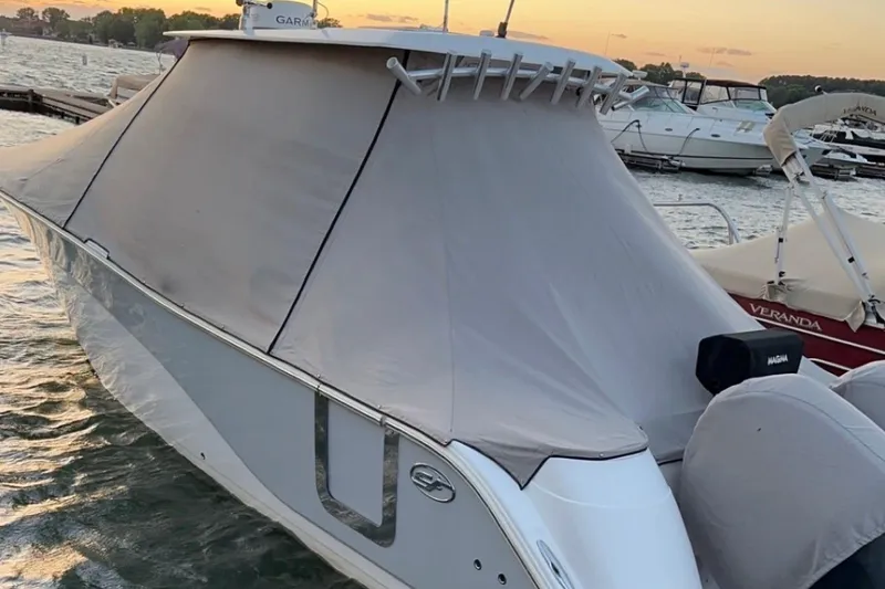Slide: The Image of 2019 Sea Fox 328 Commander boat covered at dock during sunset. - 9