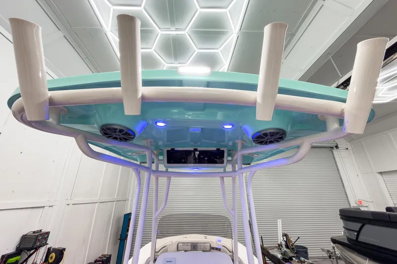 Slide: The Image of 2026 Carolina Skiff 24 Ultra Elite with blue roof and speakers. - 27