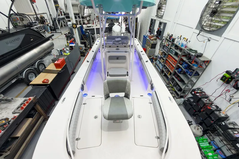 Slide: The Image of Interior view of a 2026 Carolina Skiff 24 Ultra Elite boat in a workshop. - 35