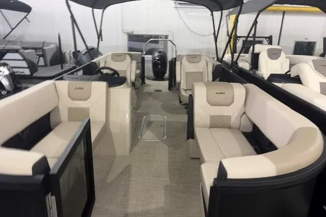 Slide: The Image of 2026 Alera A22Q boat interior with beige seating and modern design. - 10