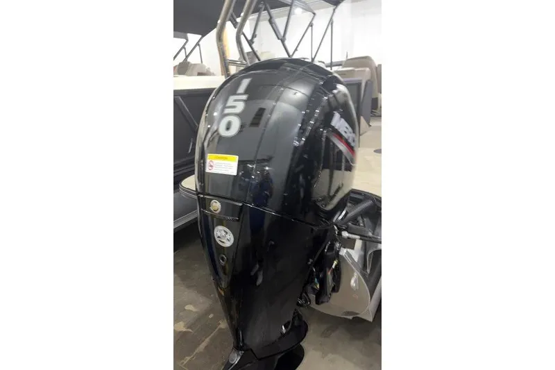Slide: The Image of Alera A22Q 2026 boat engine, black with "150" marking, in a showroom setting. - 17