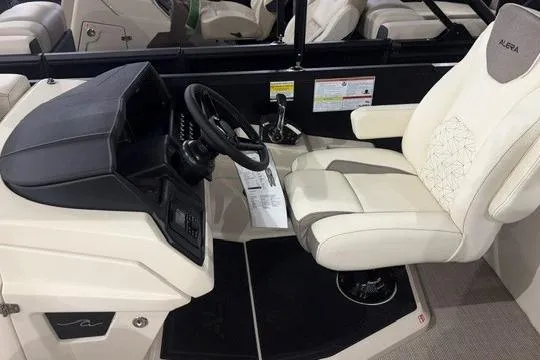 Slide: The Image of Captain's seat and helm of 2026 Alera Marine M23Q boat, featuring modern controls and design. - 8