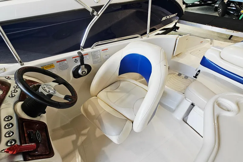 Slide: The Image of 2012 Tahoe 215 Xi boat interior with steering wheel and white-blue seating. - 10
