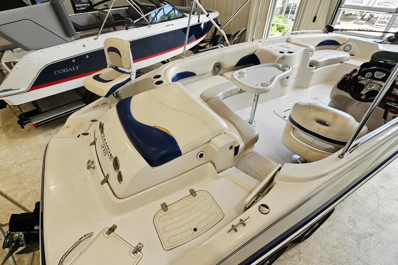 Slide: The Image of 2012 Tahoe 215 Xi boat interior with seating and control panel in showroom. - 15