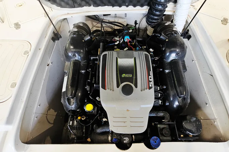 Slide: The Image of Engine compartment of a 2012 Tahoe 215 Xi boat, featuring a MerCruiser 5.0 MPI engine. - 16