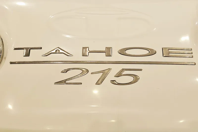 Slide: The Image of 2012 Tahoe 215 Xi emblem on a white surface, showcasing sleek metallic lettering. - 18
