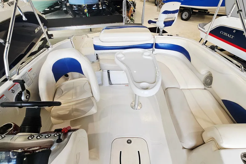 Slide: The Image of Interior of a 2012 Tahoe 215 Xi boat with white and blue seating. - 8