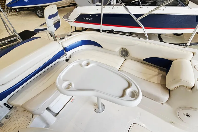 Slide: The Image of Interior of a 2012 Tahoe 215 Xi boat with white and blue seating. - 9