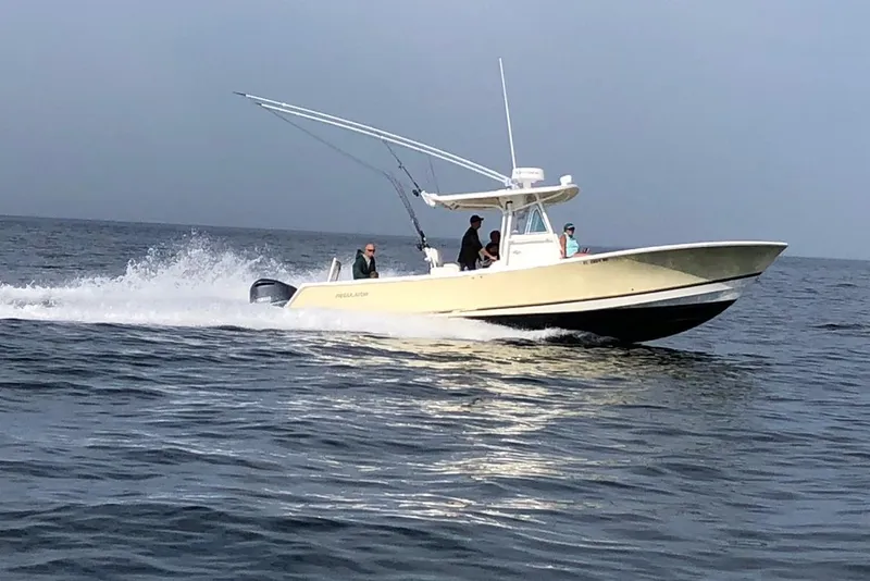 The Image of 2005 Regulator 32 Forward Seating boat cruising on open water. - 0