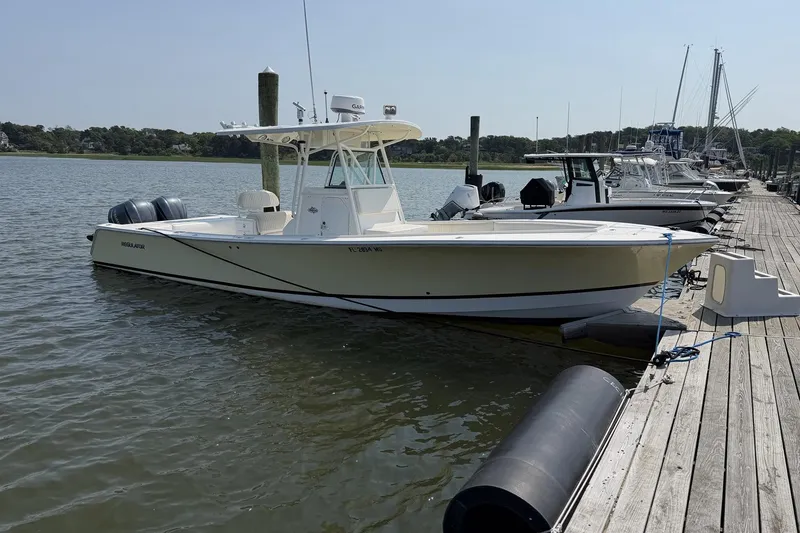 The Image of 2005 Regulator 32 Forward Seating boat docked at a marina on a sunny day. - 1