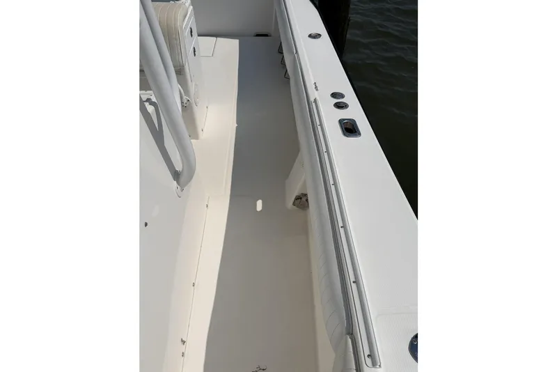 Slide: The Image of 2005 Regulator 32 Forward Seating boat deck, featuring sleek white design and modern fittings. - 18